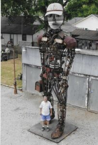 Rusty Mechanism,” the 20-foot-tall, metal man outside of The Factory at Franklin, an industrial complex that’s been transformed into a shopping and dining destination.
