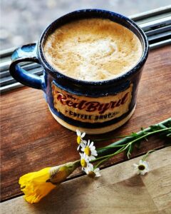 The RedByrd Coffee Shop Franklin, Tennessee, coffee in a coffee cup with RedByrd on the cup.