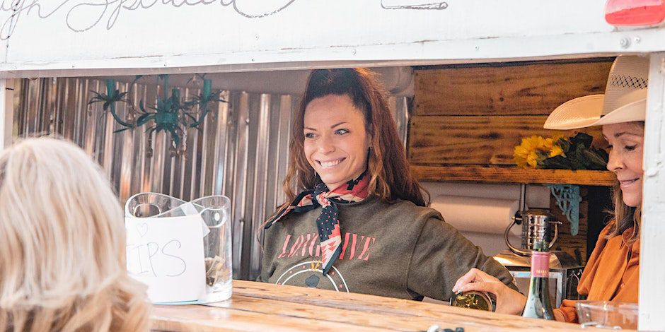 Woman smiling at Ranch Round at Trace View Ranch Franklin, TN, a night of country music and fun at Trace View Ranch! Experience an authentic Nashville style writers round with performances by Wil Nance, Josiah Siska, Andrew Bloom, Tiera Kennedy, Charly Reynolds, and Nicole Croteau.