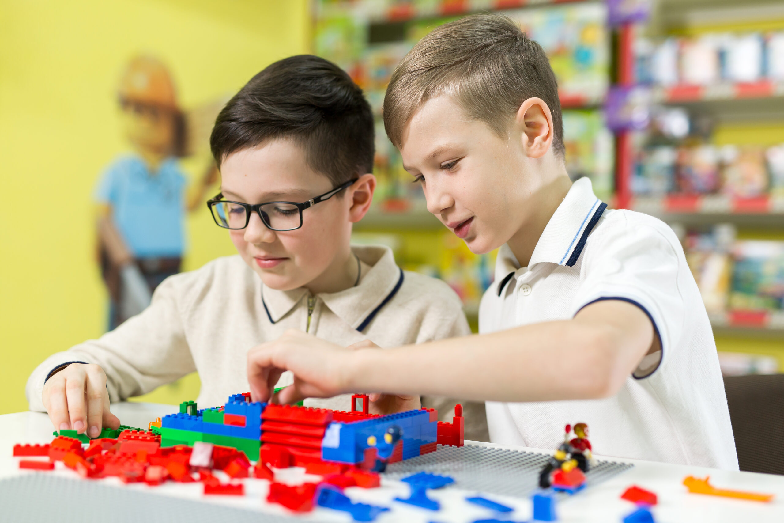 Children playing with Legos at a table.