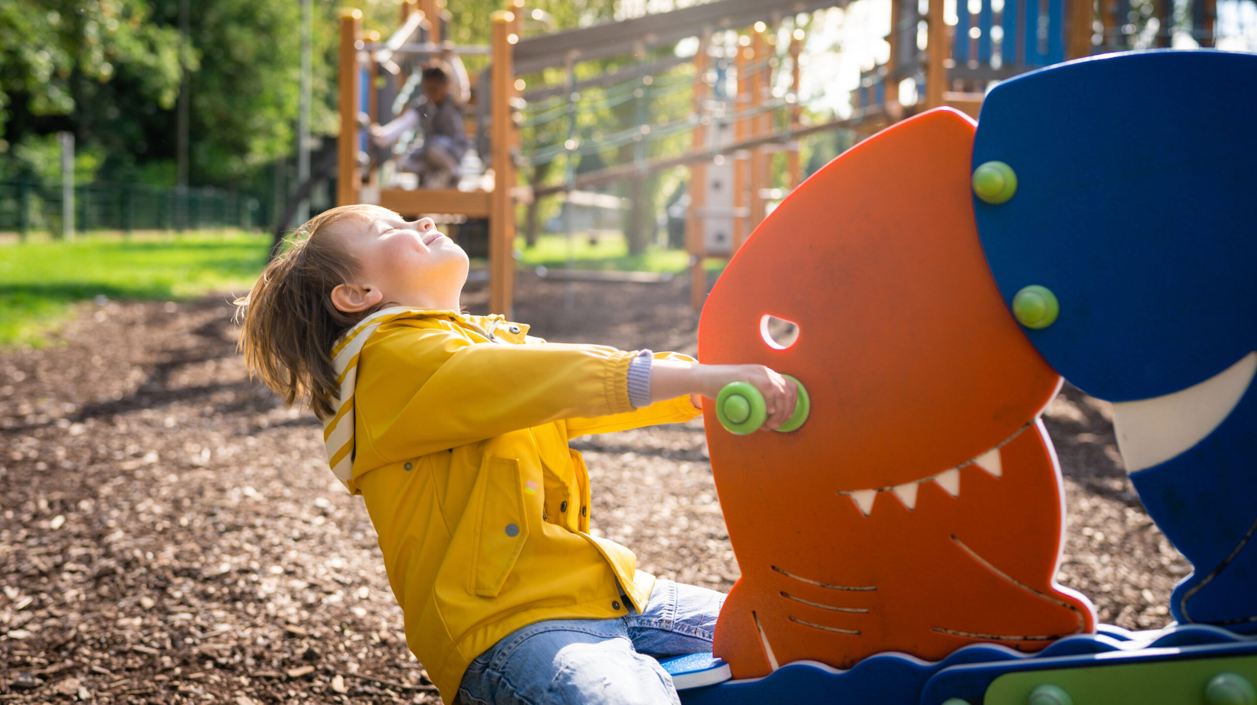 Preschool boy playing on playground in Brentwood, Tennessee.