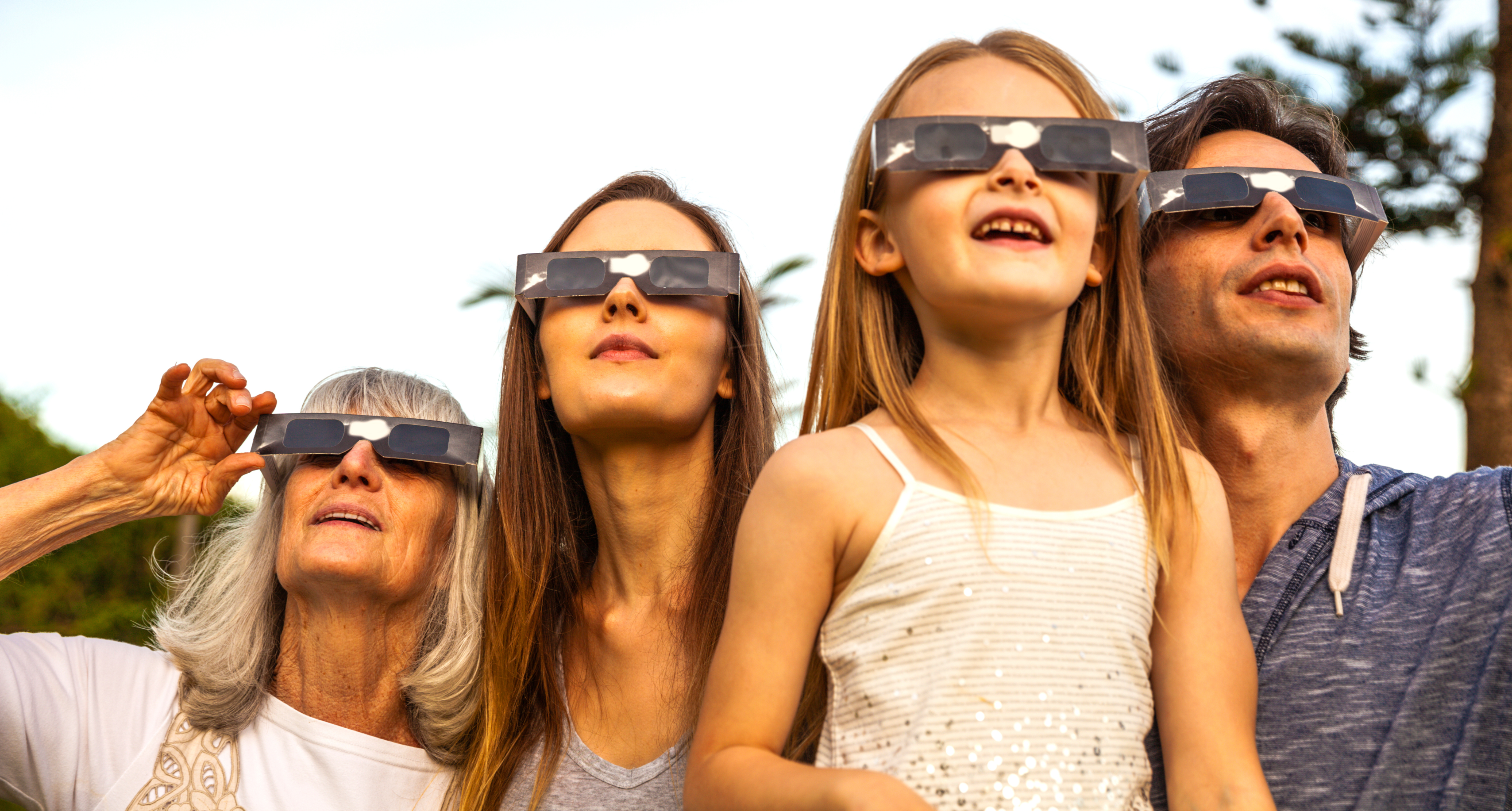 Family wearing solar eclipse glasses looking at the sky in Franklin, TN.