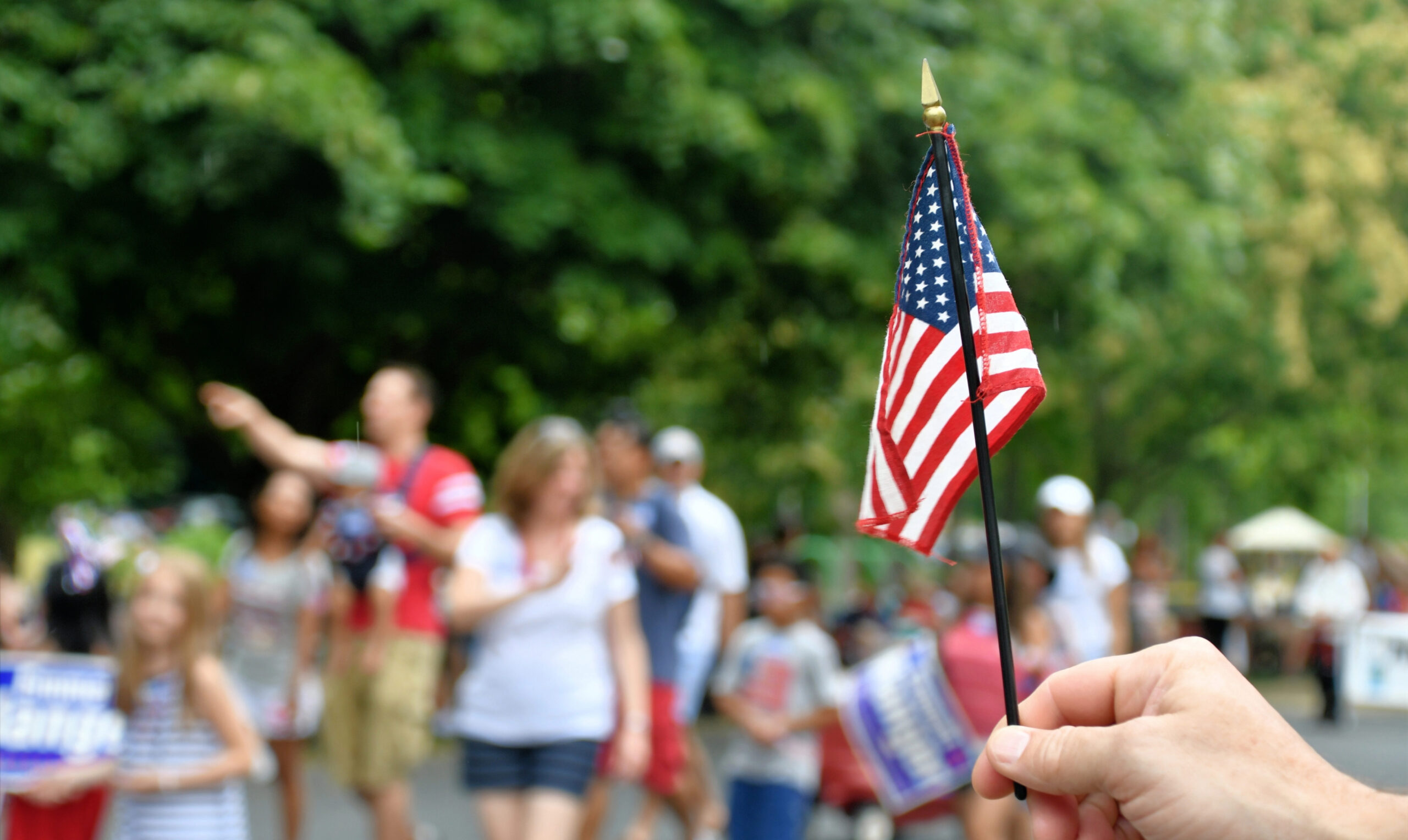 Person holding small American Flag