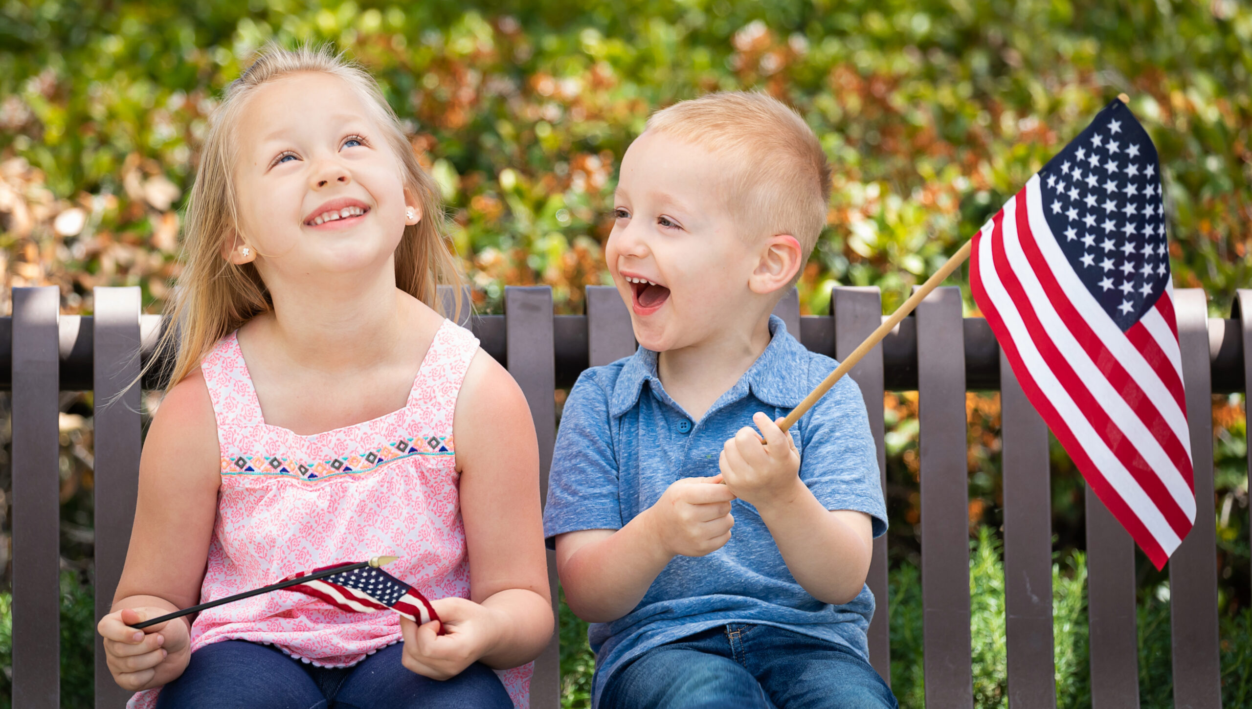 Children holding American Flags and celebrating July 4th in Franklin, Tennessee.