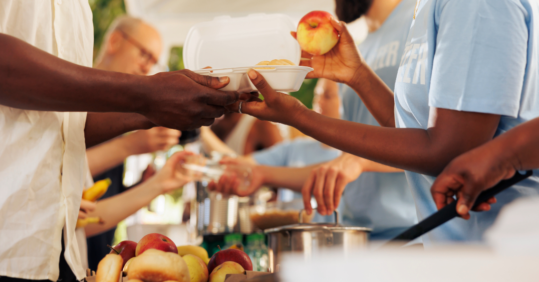 People lined up giving and receiving food