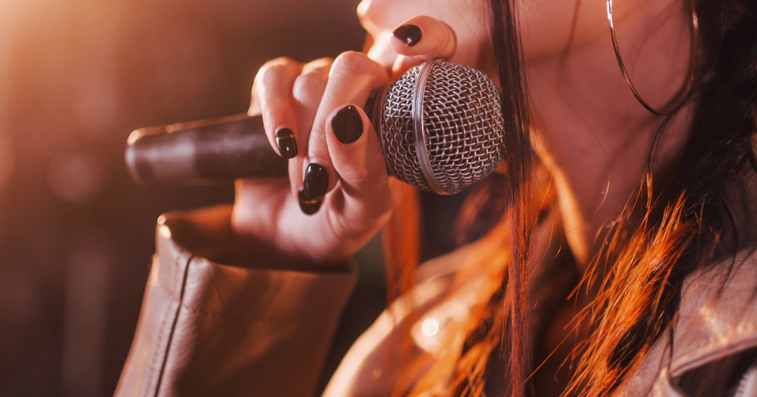 Woman singer holding a microphone.