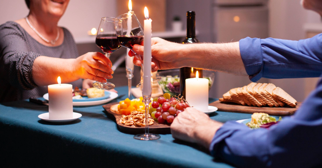 An allergy friendly restaurant in Franklin, Tenn., a couple enjoys a nice, candlelit meal with a charcuterie board and wine. 