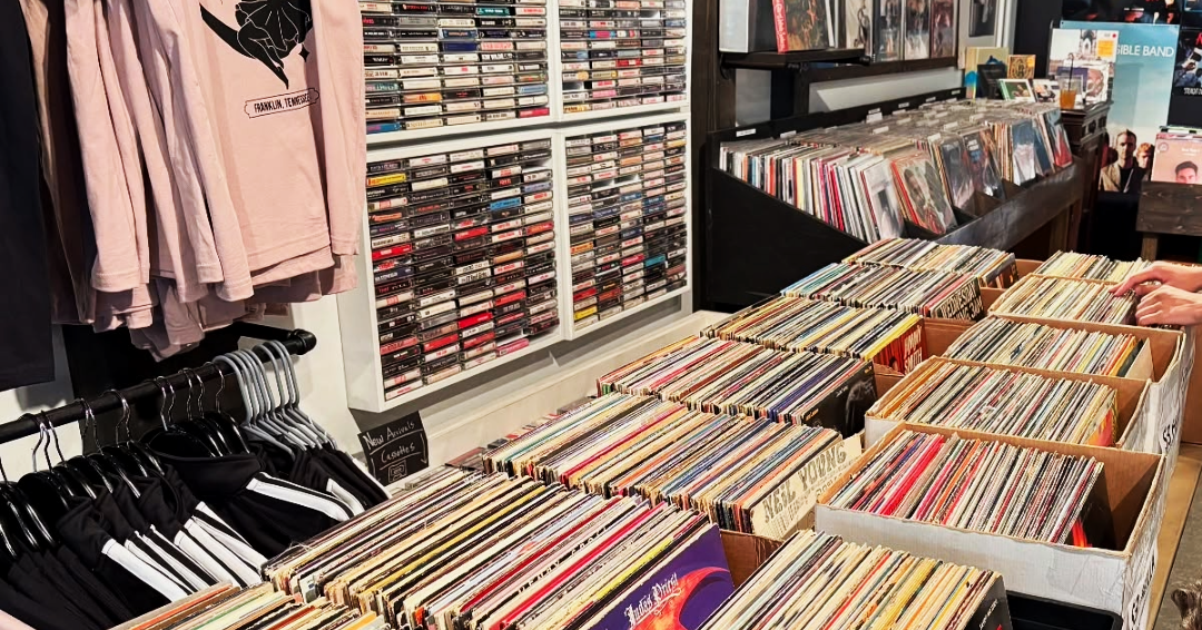 A photo of Luna Records in downtown Franklin, Tennessee, displays of vinyl records, cassette tapes, and t-shirts.