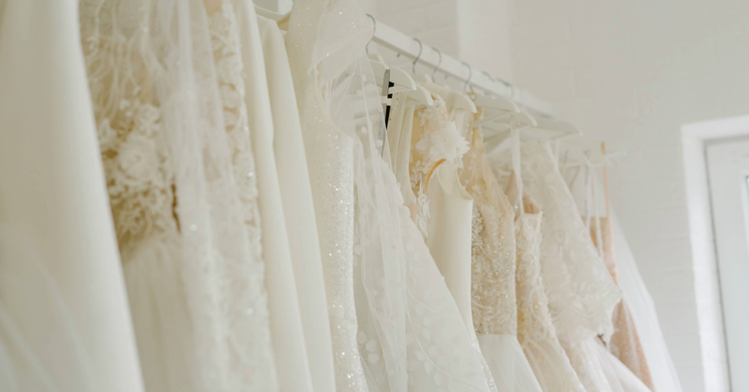 A line of wedding dresses on the rack, representing wedding dress shopping at bridal shops in Williamson County, Tennessee.