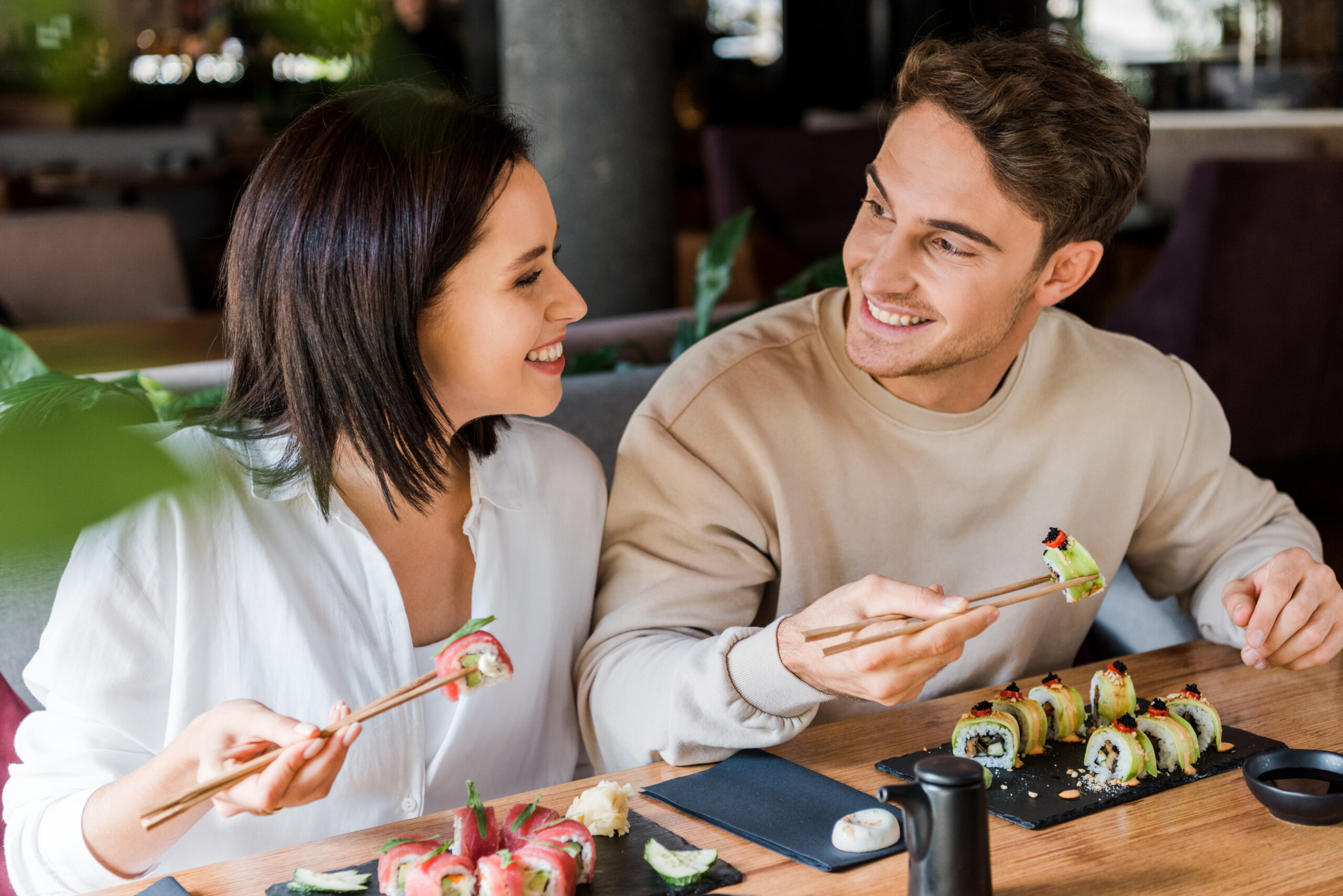 Dining at a sushi restaurant in Franklin, TN, friends enjoying sushi rolls.