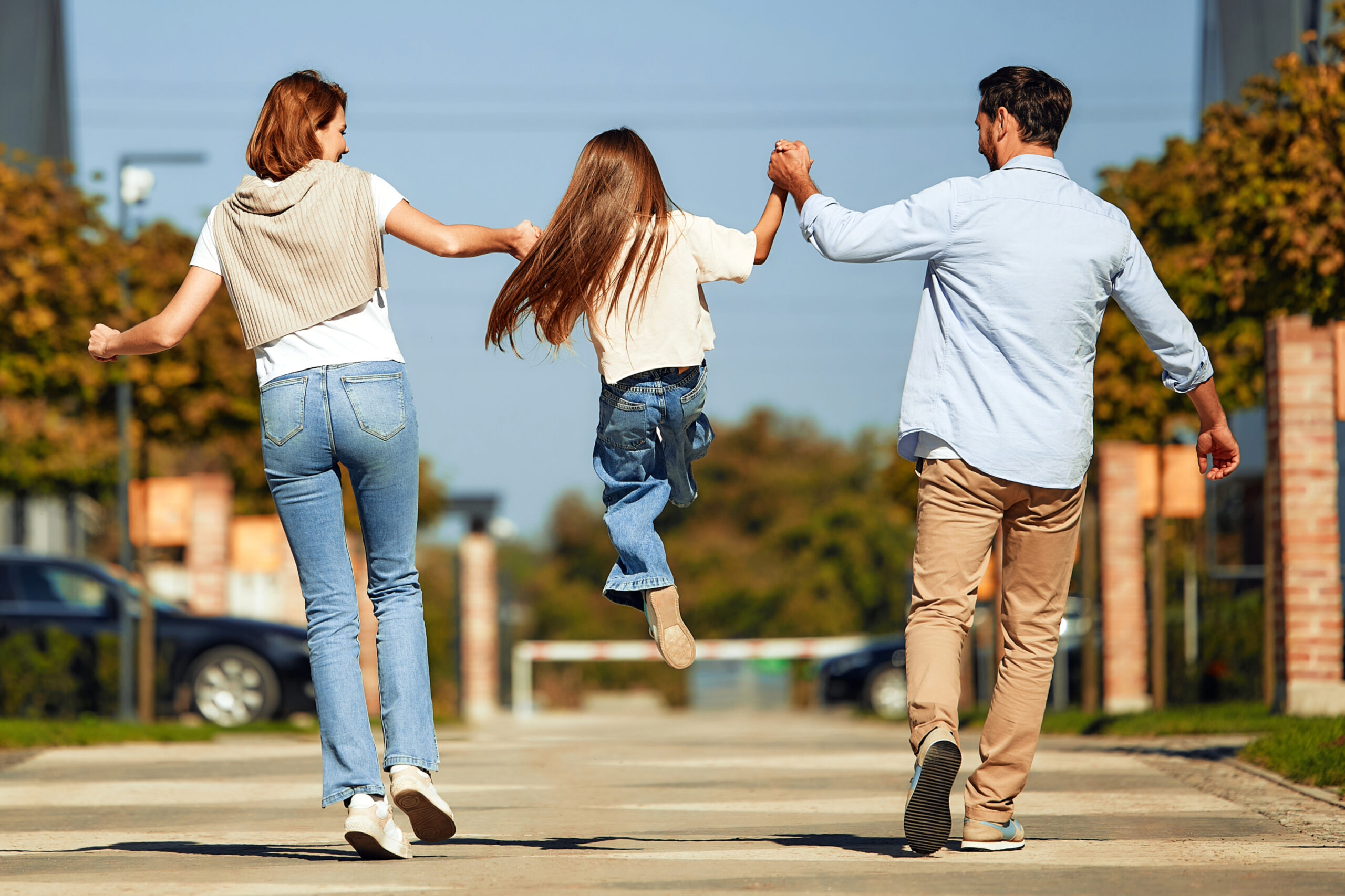 Family playing with child in the street