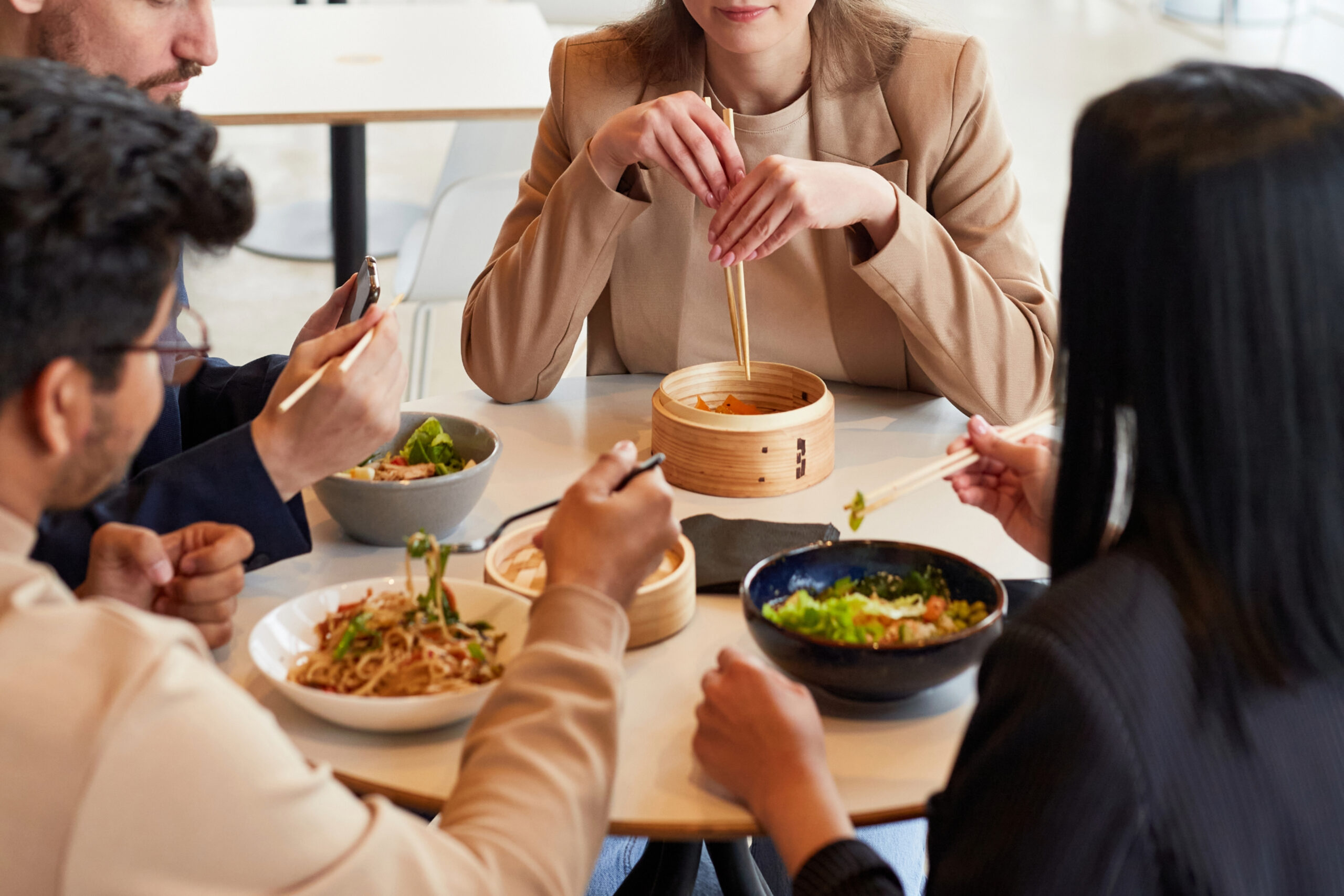 Coworkers share lunch, taking a mid-day break in Franklin, Brentwood, or Nashville, Tennessee. These cities have excellent lunch options.